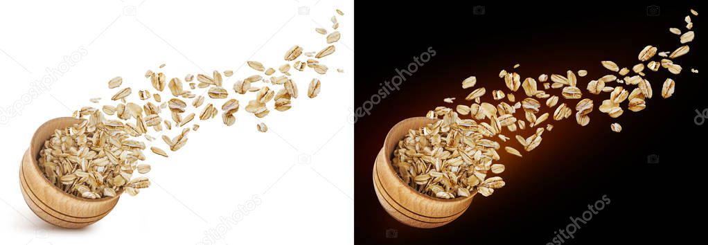 Oat flakes flying out of wooden bowl isolated on white and black background