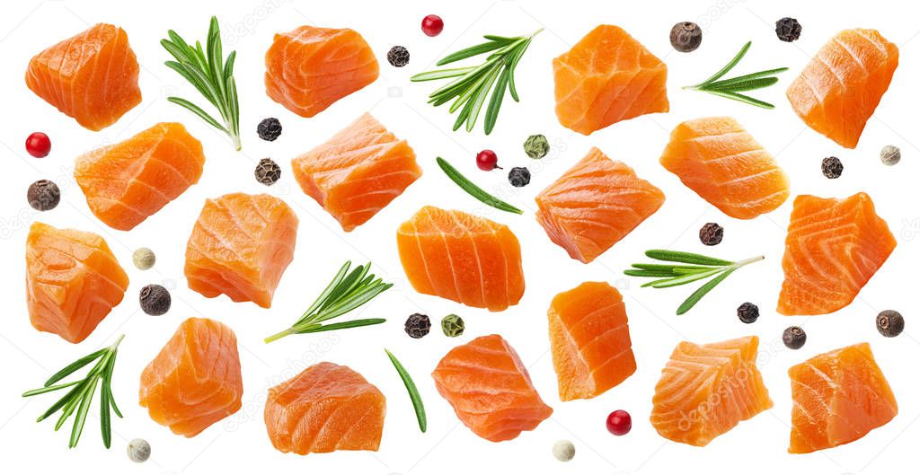 Salmon slices isolated on white background with clipping path, cubes of red fish with rosemary and peppercorns, ingredient for sushi or salad