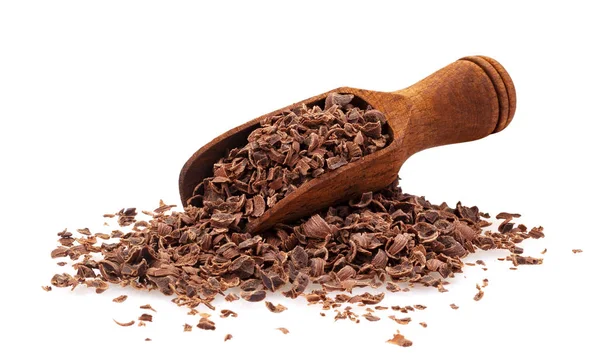 Grated chocolate. Pile of ground chocolate with wooden scoop isolated on white background, closeup
