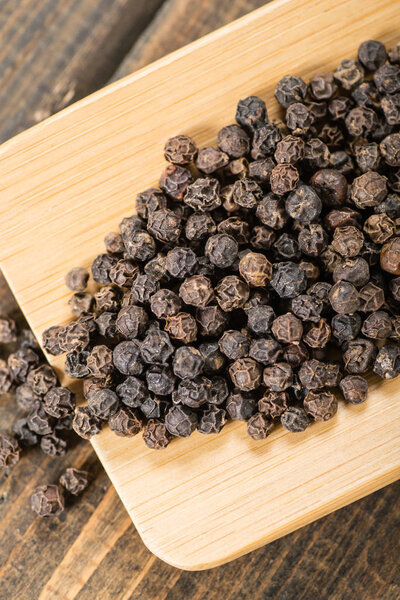 black pepper on bamboo board