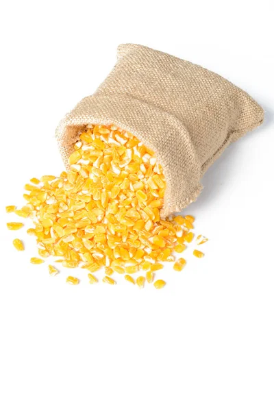 yellow corn grits in sack isolated on white background