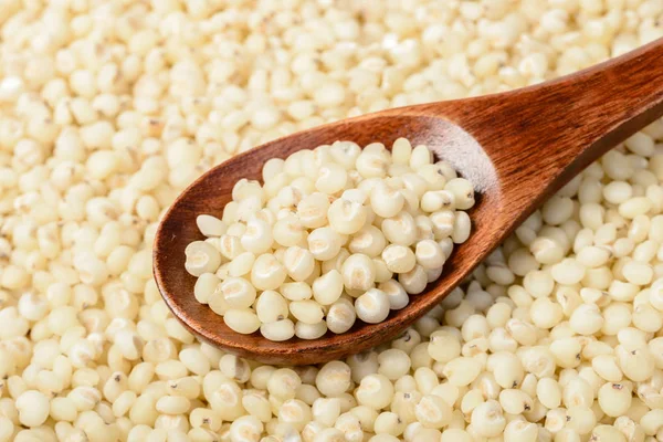 food background of sorghum with wooden scoop