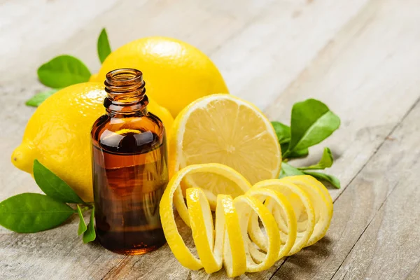 lemon essential oil and lemon fruit on the wooden board, (taken with tilt shift lens)