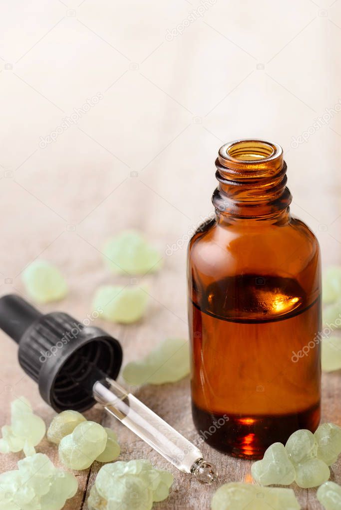 Frankincense essential oil on the wooden board