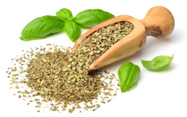 Kuru ot, ahşap kepçe içinde fesleğen yaprakları beyaz arka plan üzerinde izole