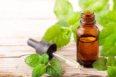 oğul otu esans ahşap tahta üzerinde şişe