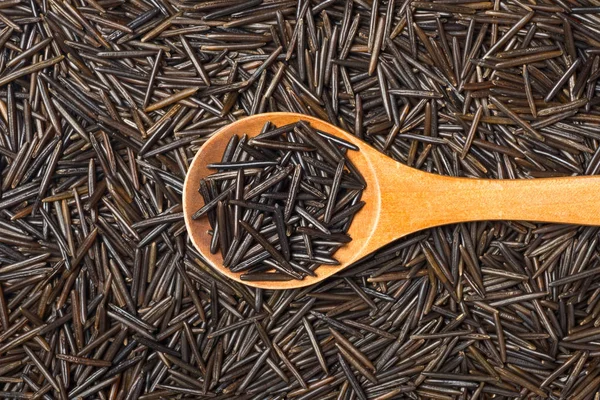 food background of black wild rice, top view