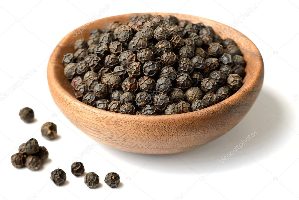 dried black peppercorns isolated on the white background