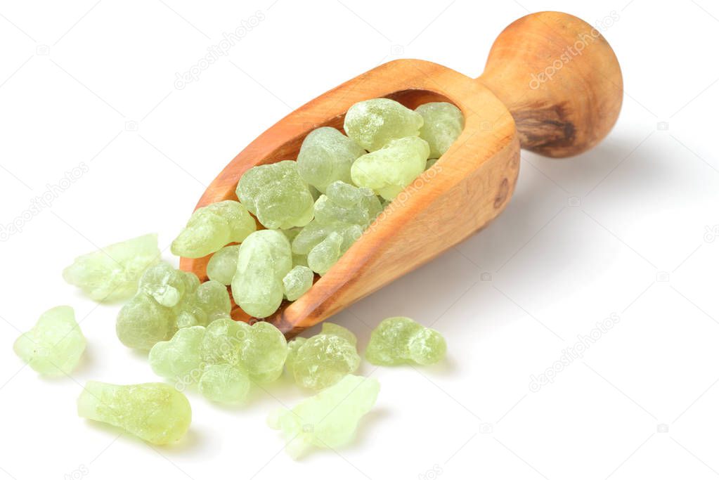 Royal Green Hojari Frankincense in the wooden spoon, isolated on the white background