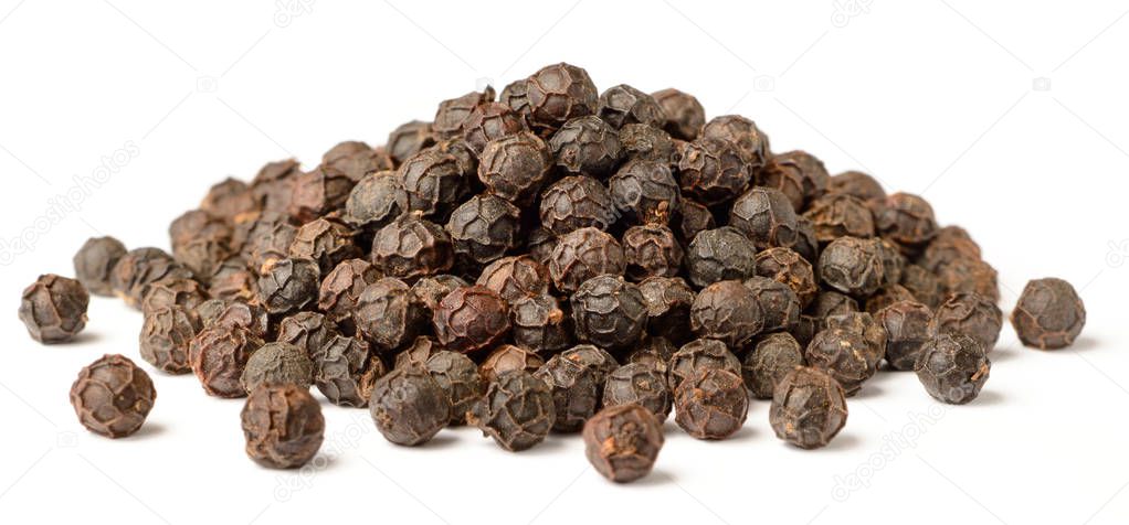 close up of dried black peppercorns isolated on white background