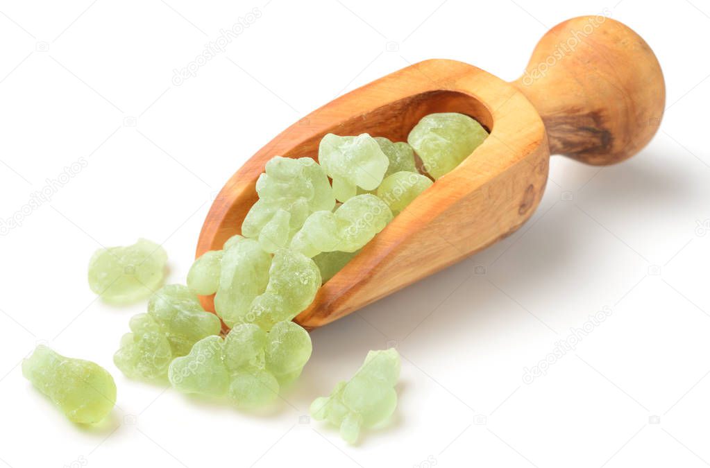 Royal Green Hojari Frankincense in the wooden spoon, isolated on the white background