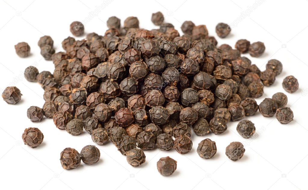 close up of dried black peppercorns isolated on white background
