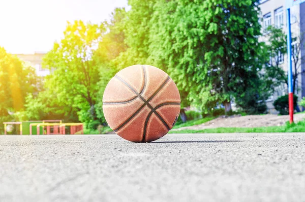 ball for playing basketball lies on the sports ground