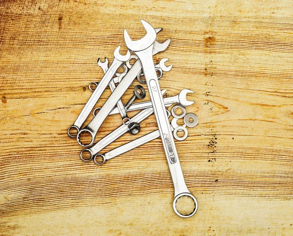 Spanners on a wooden board, top view
