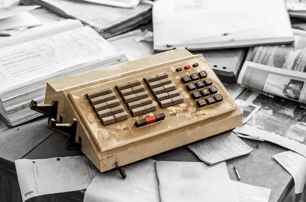 Old vintage junk telephone switch with buttons on the desk with documents