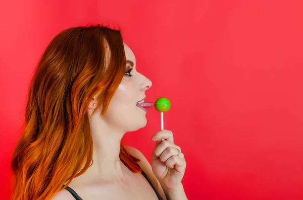 Portrait Cheerful Beautiful Woman Sucks Licking Caramel Stick Red Background — Stock Photo, Image