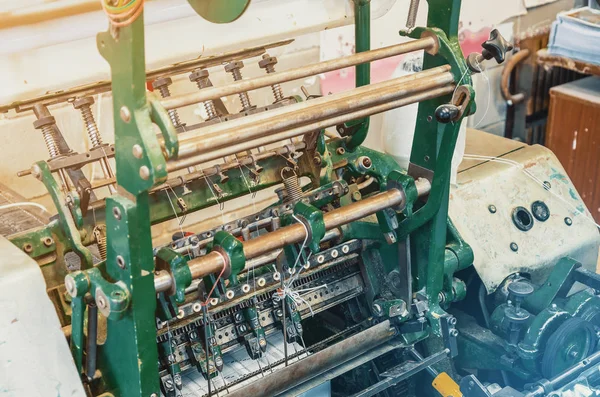 Machine for stitching sheets of paper in printing. Magazine, brochure, book. Production of printed products. Vintage technology