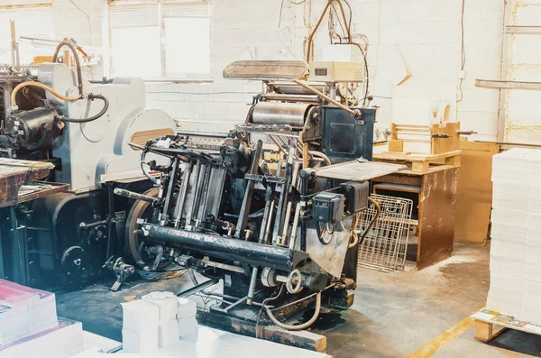 Old vintage printing machine for cutting cardboard in printing house. Box, production.