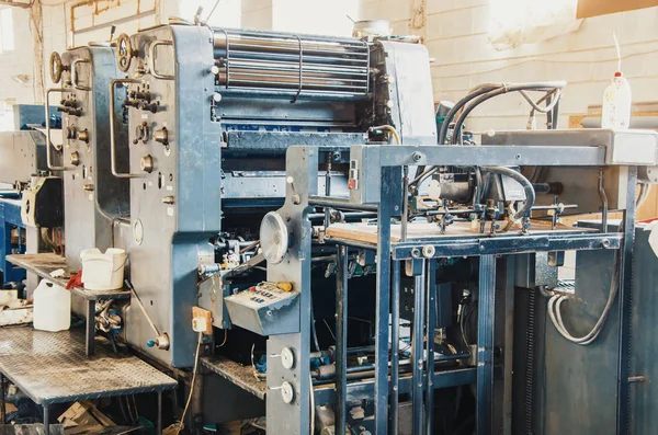 Old vintage printing machine in print shop. Magazine, newspaper, brochure, paint.