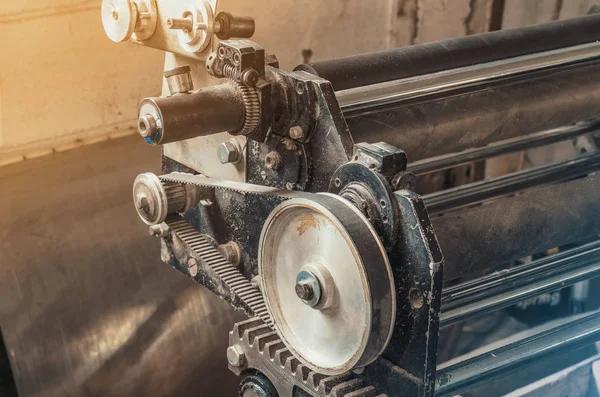 Elements of vintage printing machine, gears, suckers, paper pulling.