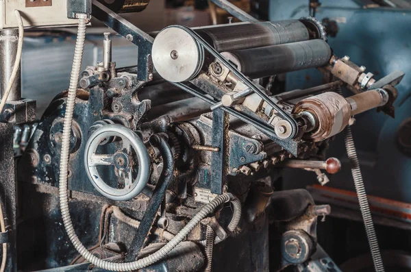Vintage printing machine for carving in printing. Part of old mechanism, regulators, gears.