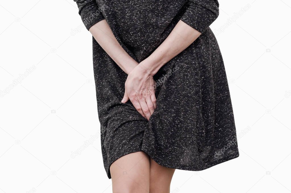 Slender girl in a dark dress experiences discomfort in the uteru