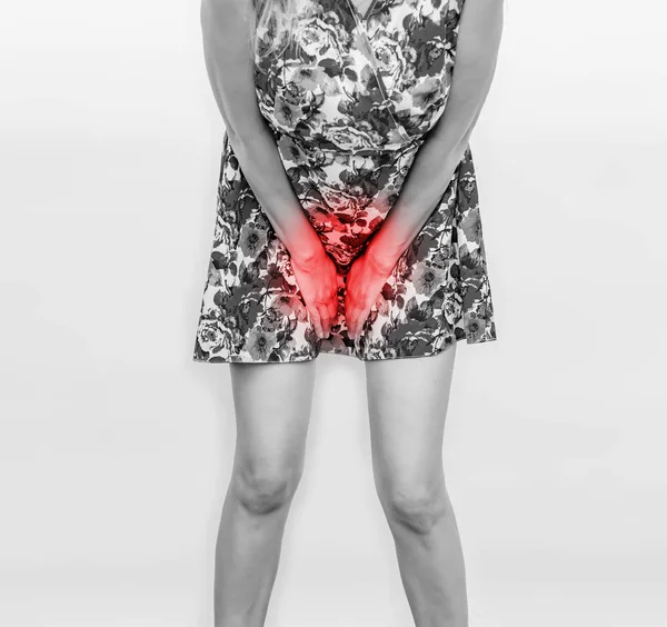 Woman in a colored dress presses her hands to her stomach — Stock Photo, Image