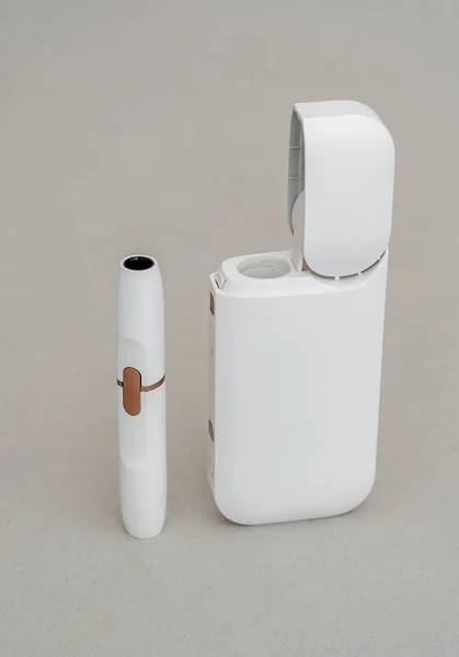 Box-case with a mouthpiece for an electronic cigarette with a white color on a gray background