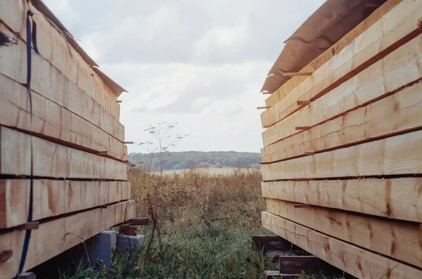 Pine boards in stacks stacked in nature.