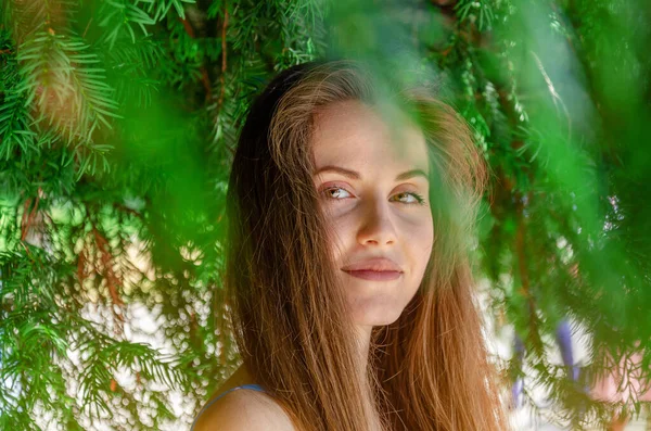 Νεαρή Ελκυστική Γυναίκα Στέκεται Κάτω Από Ένα Πράσινο Δέντρο Κοιτάζει — Φωτογραφία Αρχείου