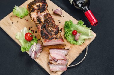 Şarap seti, domuz eti, sebze, baharat. Tahtada, fırında domuz eti, sebze ve baharatla servis ediliyor. Akşam yemeği için bir takım ürünler. Restoran menüsü.