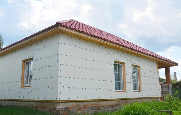 Unfinished house insulation ready for  plastering wall with rigid foam insulation. House foam insulation for energy saving.