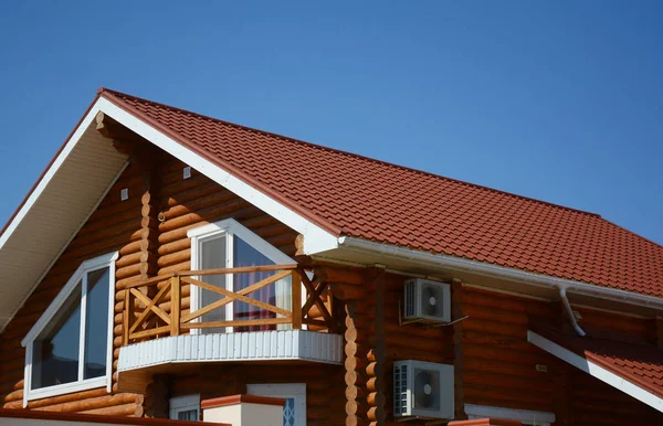 Wooden house with metal roof, attic, air duct, balcony, rain gutter