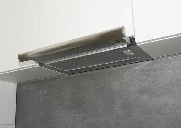 Cooker Hood. Modern air exhauster kitchen fan or range hood. Stainless steel chimney hood. Island hood.