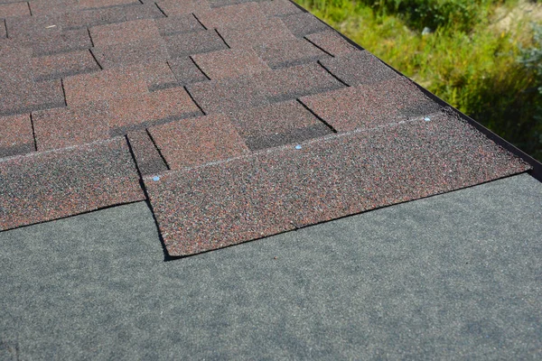 Asphalt shingles installing on house construction roof. Roofing construction. Installing roof tiles.
