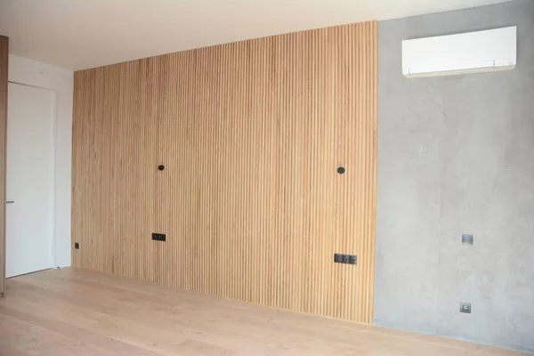 Modern interior house room with wooden floringa, wooden wall decoration and air conditioning
