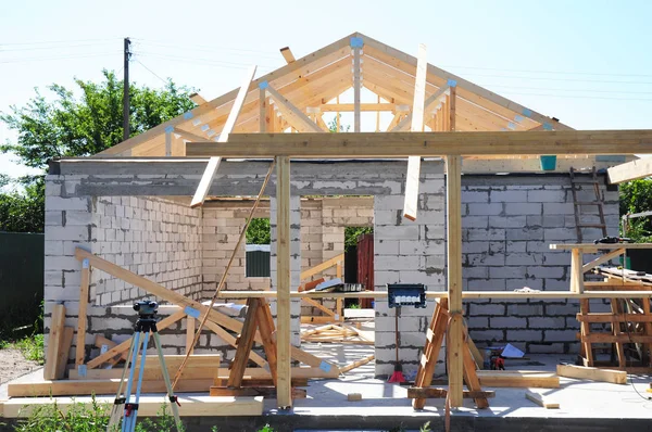 Roofing construction with wooden frame beams, timber, trusses and house construction aerated concrete blocks work.
