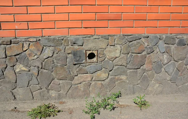 House foundation wall ventilation hole.