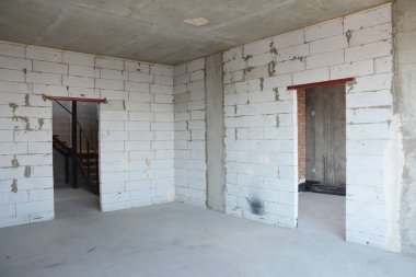 Interior room under construction, metal door lintels. Wall without plasterwork. clipart