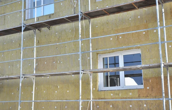 Solid wall insulation with rock wool. Energy efficiency house wall renovation for energy saving. Exterior building wall heat insulation with mineral wool. External wall insulation
