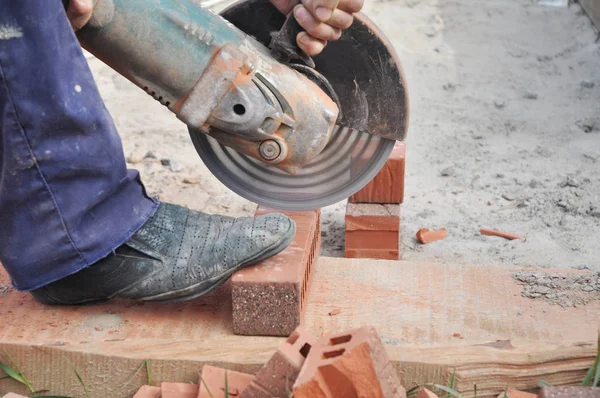 Cutting Brick with a Diamond Saw. Masonry Cutting. Contractor Cut a Brick With a Wet Saw. Circular saw is a power-saw with disk.