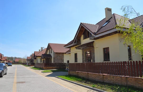 Neighborhood street in modern cottage town.  Beautiful street with new modern houses.