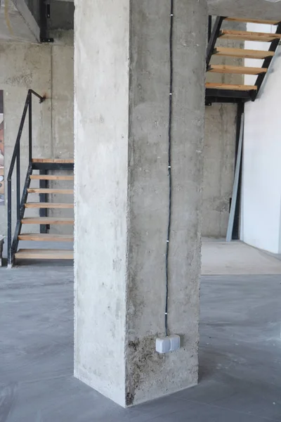 House concrete column with wire and outlet plug.
