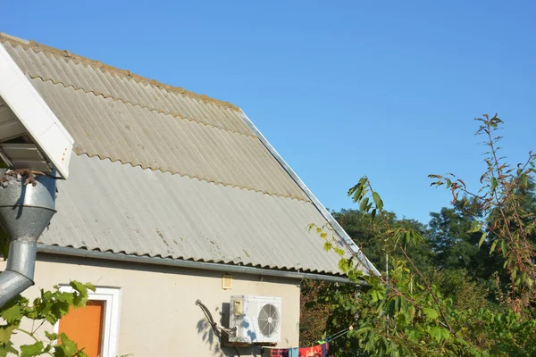 Asbestos roof with house metal gutter and air duct — Stock Photo, Image