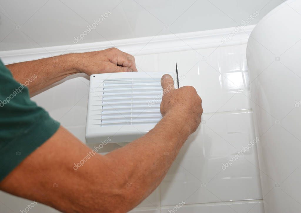 Bath fan repair, installation. Handyman installing new bath vent fan, ventilation system in the house bathroom 