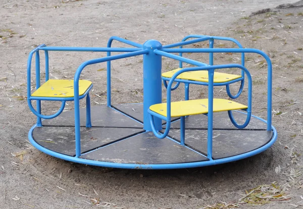 Playground roundabout (or merry-go-round) at children playground — Stock Photo, Image