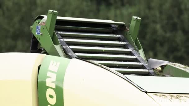 Working conveyor belt of combine harvester near forest — Stock Video