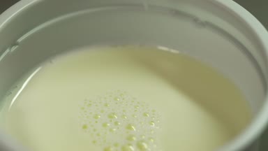 Kimyasal test için hazırlık. Laboratuar asistanı süt şırınga alır.