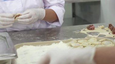 Beyaz eldiven kadın işçilerin et hamur içinde sarın. Köfte yapma. Fabrika
