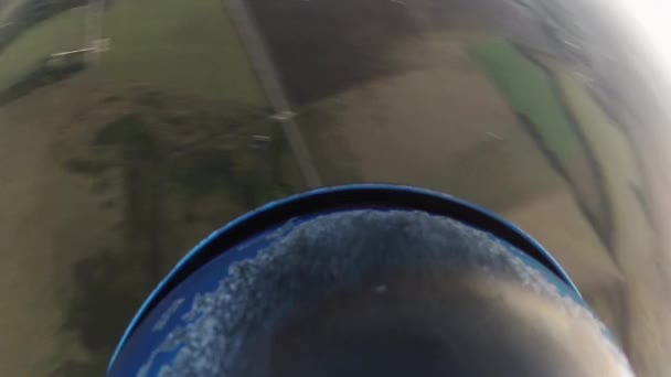 Skydiver parachuting in sky above green land. Extreme sport activity. Adrenaline — Stock Video